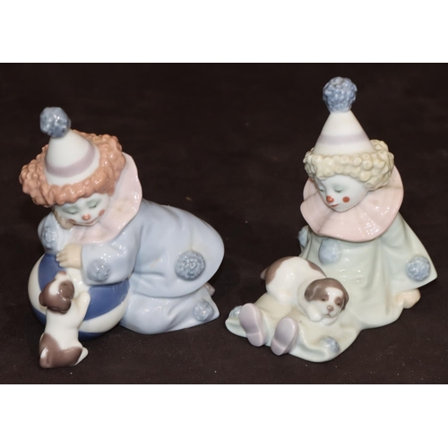 86 - A pair of Lladro figures of seated clown, children with puppies, largest 12cm high