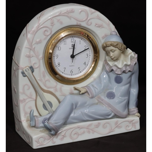 89 - A Lladro arched topped clock with raised seated Pierrot, 20cm high