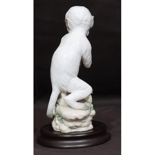 90 - A Lladro figure of a seated monkey holding a flower 