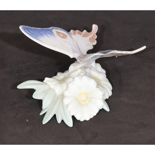 92 - A Lladro figure of a butterfly perched on a flower, 13cm wide, 8cm high