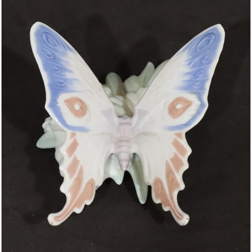 92 - A Lladro figure of a butterfly perched on a flower, 13cm wide, 8cm high