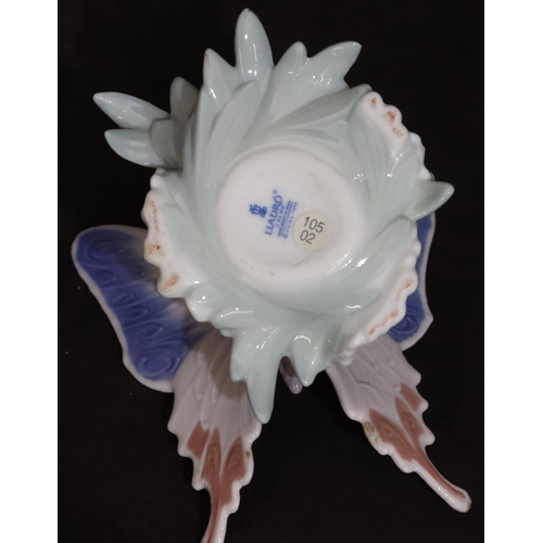 92 - A Lladro figure of a butterfly perched on a flower, 13cm wide, 8cm high