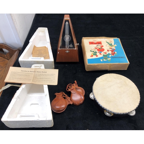 7022 - A traditional metronome, System Maelzel, Germany, boxed, a 19cm diameter tambourine, boxed, and a pa... 