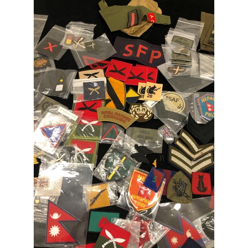 7036 - A large quantity of various military patches, including Ghurkha, Desert Rat, Nepal Armed Police Forc... 