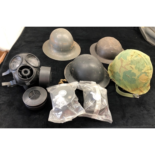 7039 - 4 steel military helmets and a gas mask with additional filters.