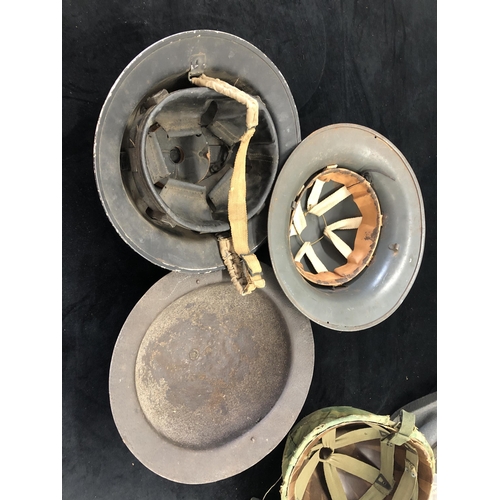 7039 - 4 steel military helmets and a gas mask with additional filters.