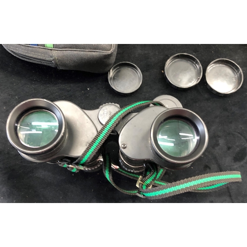 7042 - A pair of Chinon Sportsman 7-15 x 35 binoculars in zipped case, a World War II in colour DVD a Help ... 