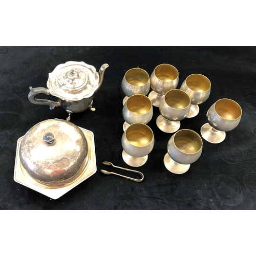 7051 - A silver plated muffin dish, teapot (handle loose), 8 goblets and a pair of sugar nips.