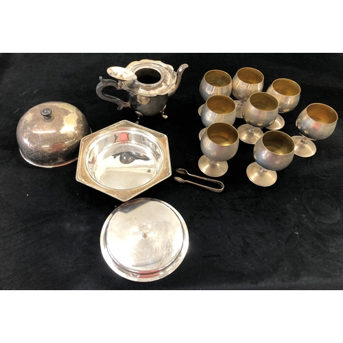 7051 - A silver plated muffin dish, teapot (handle loose), 8 goblets and a pair of sugar nips.