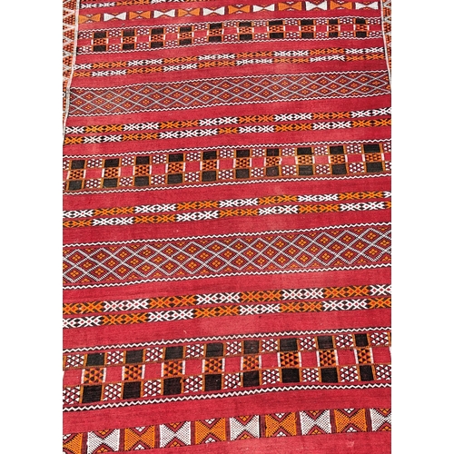 7069 - A Kilim style woven rug, 130 x 200cm (tassels missing to 1 end)