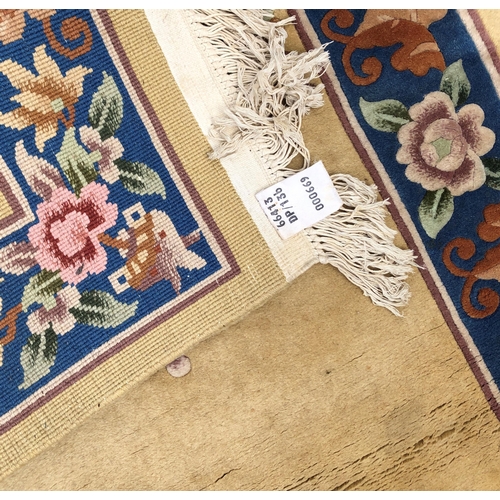 7070 - A wool rug on cream ground with floral pattern, 92 x 183cm (some scattered spots).