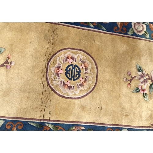 7070 - A wool rug on cream ground with floral pattern, 92 x 183cm (some scattered spots).