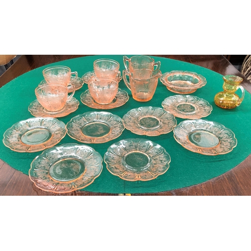 7100 - A pink tinted glass part tea service, 4 cups, 11 saucers, 1 small bowl, 1 jug, 1 2-handled cup, l pl... 