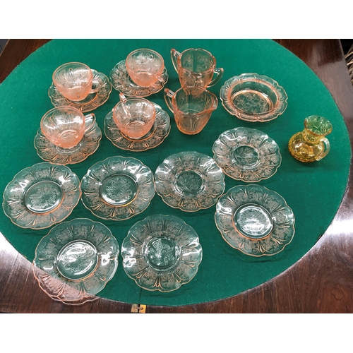 7100 - A pink tinted glass part tea service, 4 cups, 11 saucers, 1 small bowl, 1 jug, 1 2-handled cup, l pl... 