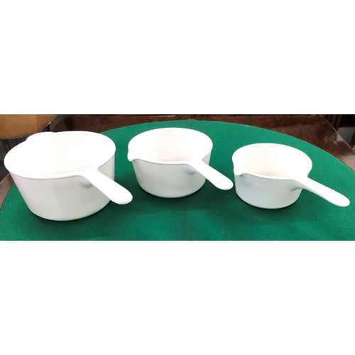 7101 - A set of 3 Corning France, graduated white saucepans