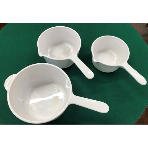 7101 - A set of 3 Corning France, graduated white saucepans