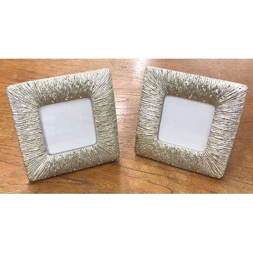 7137 - A pair of silver coloured photograph frames, 17 x 17cm by Rachel Zoe and a wood wall hanging spice b... 