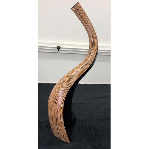 7139 - A modern wood curved vase, 74cm high.