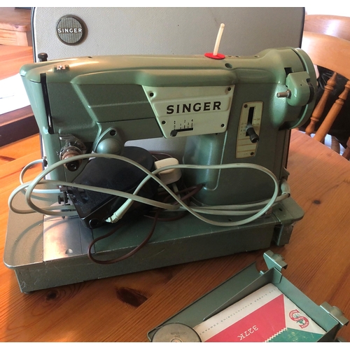 7171 - A vintage Singer electric sewing machine with hard carrying case, foot pedal and various accessories... 