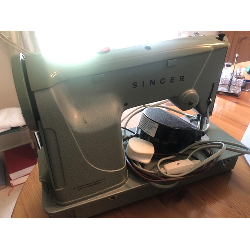 7171 - A vintage Singer electric sewing machine with hard carrying case, foot pedal and various accessories... 