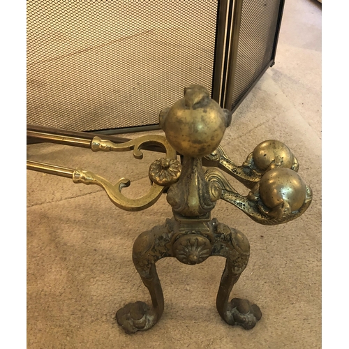 7185 - A 4-sectioned brass fire guard, 81cm high, 130cm wide open and a pair of brass fire dogs with ball a... 