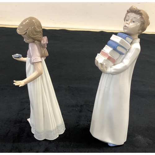 7216 - A Nao figure of girl holding a candlestick, 26cm high (1 finger on each hand a/f) and a Nao boy carr... 