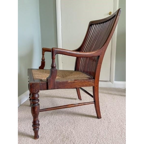 7220 - A 19/20th Century mahogany armchair with slatted back and drop-in rush seat (dropped), width 47cm (w... 