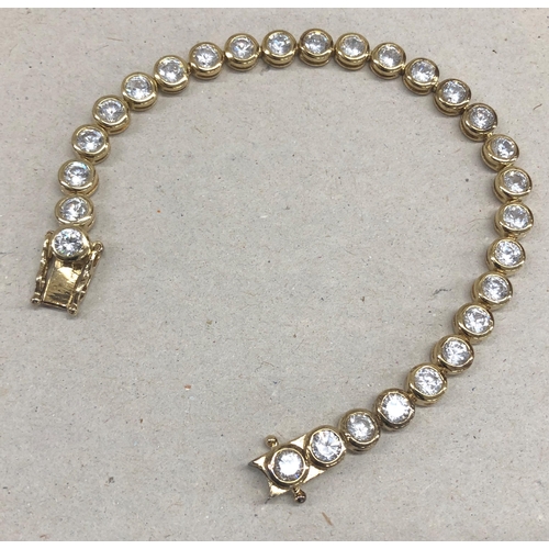 7244 - A 925 silver gilt bracelet with clear stones, 19.5cm long overall.