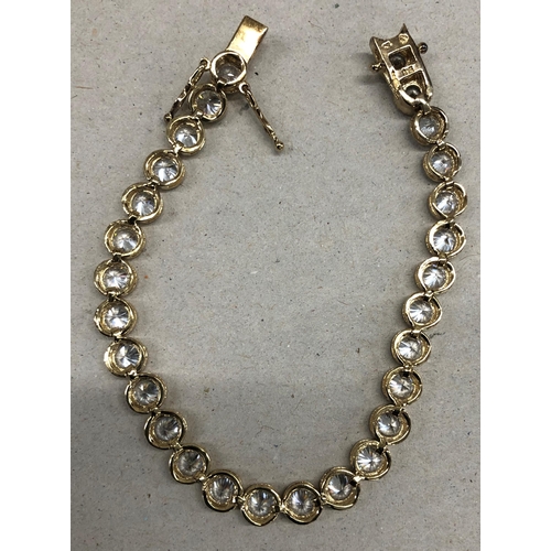 7244 - A 925 silver gilt bracelet with clear stones, 19.5cm long overall.