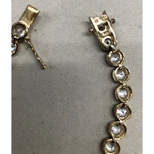 7244 - A 925 silver gilt bracelet with clear stones, 19.5cm long overall.