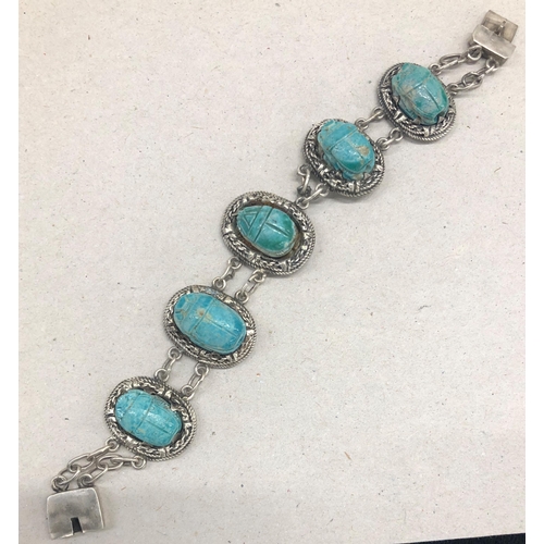 7245 - A silver coloured panel bracelet with blue scarab beetle stones, 19cm long (1 link a/f)