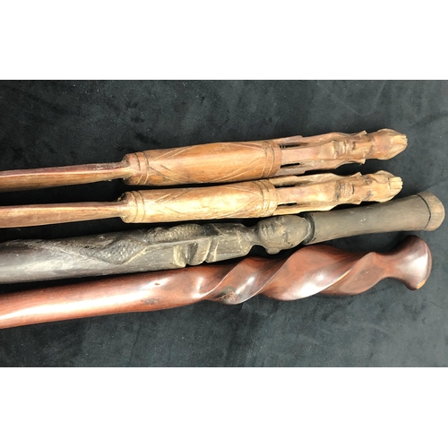 7257 - 2 African walking sticks, longest heavy wood 90cm long and a pair of African clubs, 67.5cm long. (4)