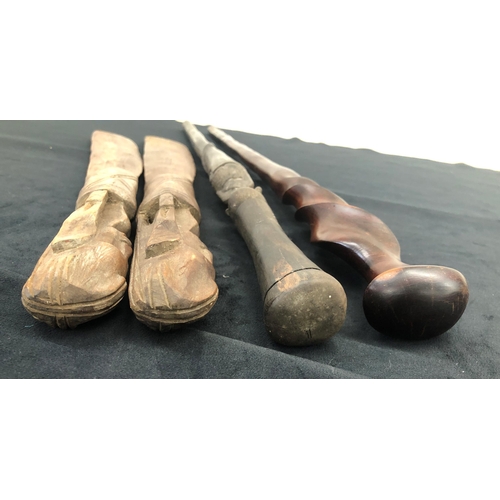 7257 - 2 African walking sticks, longest heavy wood 90cm long and a pair of African clubs, 67.5cm long. (4)