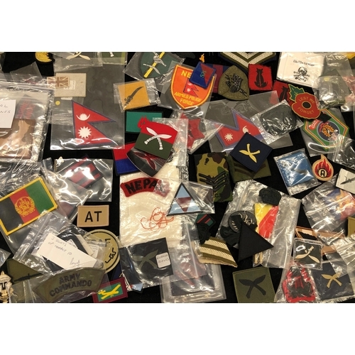 7036 - A large quantity of various military patches, including Ghurkha, Desert Rat, Nepal Armed Police Forc... 