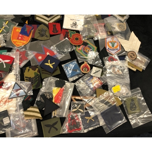 7036 - A large quantity of various military patches, including Ghurkha, Desert Rat, Nepal Armed Police Forc... 