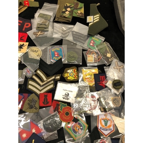 7036 - A large quantity of various military patches, including Ghurkha, Desert Rat, Nepal Armed Police Forc... 