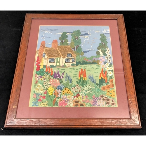 7080 - A hand embroidered picture of a cottage and garden, 34.5 x43cm in wood frame.