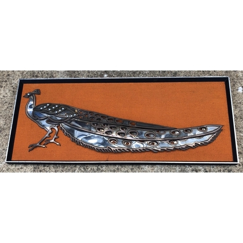 7094 - A stainless steel Peacock on fabric background and in wood frame, circa 1960, 100.2 x 42cm overall