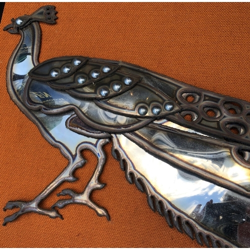 7094 - A stainless steel Peacock on fabric background and in wood frame, circa 1960, 100.2 x 42cm overall