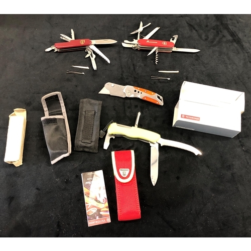 7149 - A Swiss Army Camping penknife, another Swiss Army penknife, a Victorinox Swiss Rescue Tool and anoth... 