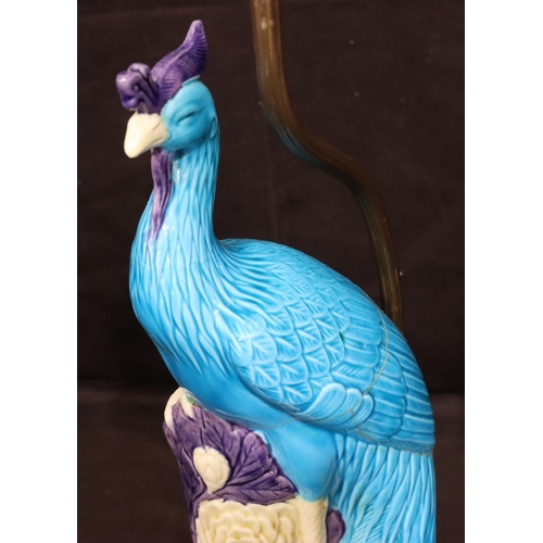 128 - An Oriental table lamp in the form of a perched bird on purple, turquoise and white ground, mounted ... 