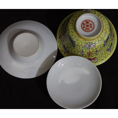 133 - A Chinese round bowl with cover and saucer on yellow ground with multi-coloured bat, scroll, floral ... 