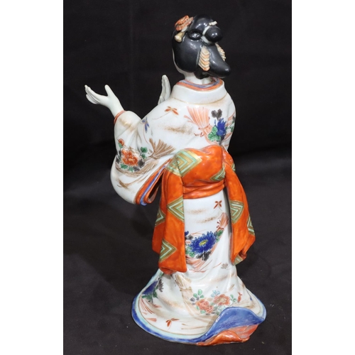 144 - An Oriental china figure of a standing Geisha girl, 23.5cm high (left hand restored)