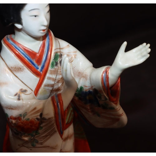 144 - An Oriental china figure of a standing Geisha girl, 23.5cm high (left hand restored)