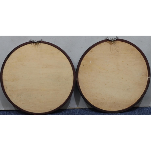 194 - A pair of circular Oriental floral pictures in black frames, 30cm diameter overall