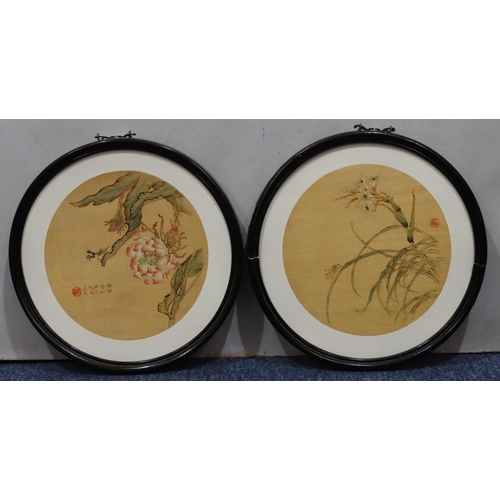 194 - A pair of circular Oriental floral pictures in black frames, 30cm diameter overall