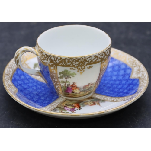 170 - A small Continental porcelain cup and saucer on blue and white ground with hand painted figure, land... 