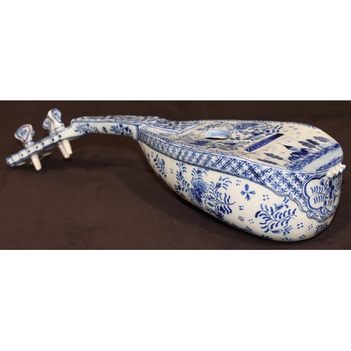 68 - A French Faience Delft style model of a mandolin on blue and white ground with building, floral, lea... 