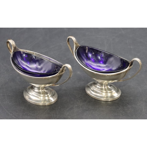 213 - A pair of London silver Victorian oval salts with blue glass liners on oval sweeping bases, 3oz, Lon... 