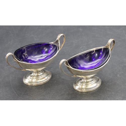 213 - A pair of London silver Victorian oval salts with blue glass liners on oval sweeping bases, 3oz, Lon... 